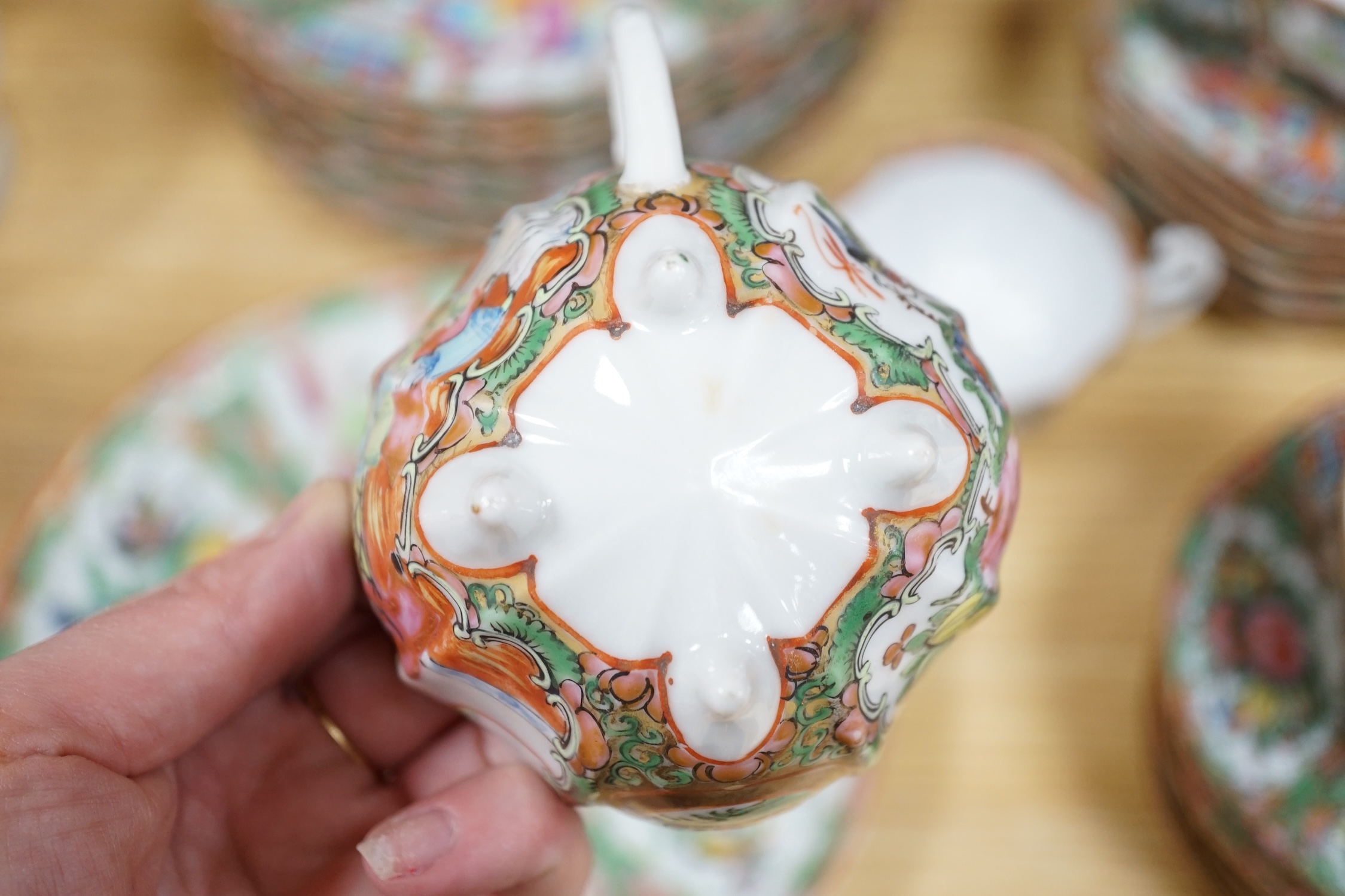 A Chinese famille rose six place setting tea service, including a large tea pot and cover, a smaller water pot and cover, two sugar bowls with covers, a large milk jug (handle broken) a small cream jug and a cake plate,(